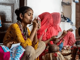 Women learning vocational skills at Priya Sarv Utthan Seva Sansthan - Economic empowerment through tailoring, handicrafts, and computer literacy programs